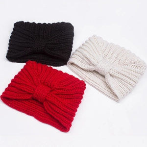 Detailed texture of knitted baby headbands in black, white and red with knot design