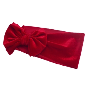 Soft red velvet baby headband with a large bow detail for Christmas hair accessory