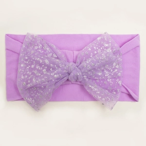 Detail of purple nylon baby headband with sequined mesh bow on white background