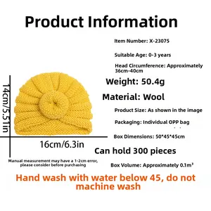 Detailed view of yellow knit baby beanie showing dimensions, soft wool texture and pom-pom