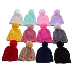 Cozy knit baby beanies with fluffy pom poms in twelve vibrant colors for winter