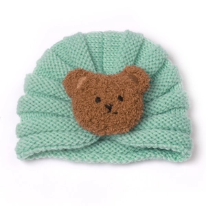 Mint green knit baby hat with a cute brown teddy bear patch for winter warmth