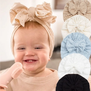 Hollow embroidered baby turban hats with large bows in beige, white, and blue colors