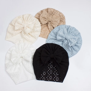 Flat lay of five lightweight mesh baby turbans with decorative bows in various colors