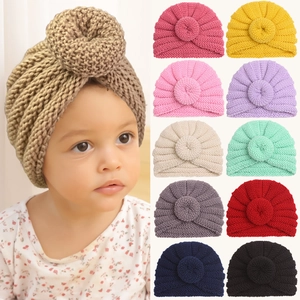 Baby winter knit donut beanie hat in eleven solid colors for infant warmth and comfort