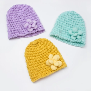 Chic knit winter hats for babies with fabric floral accents in purple, green, and yellow