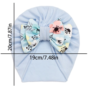 Light blue infant turban hat with floral bow showing dimensions 20cm by 19cm
