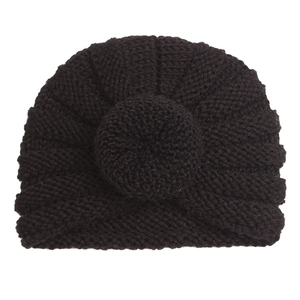 Detail of black chunky knit baby turban beanie showing texture and round knit ball