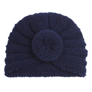 Detailed knit texture and donut design of the navy blue winter baby turban hat