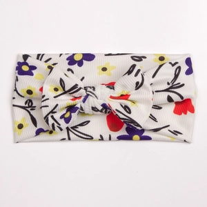 Detail of floral printed baby headband featuring soft ribbed fabric and a cute bow tie