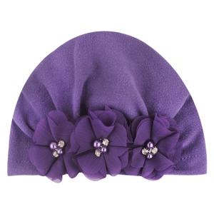 Close-up of soft purple baby turban hat with three chiffon flowers and pearl accents