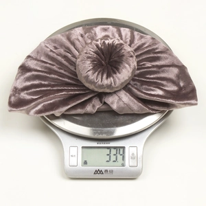 Soft gold velvet baby turban hat with donut knot in mauve, weighing 33.4g on scale