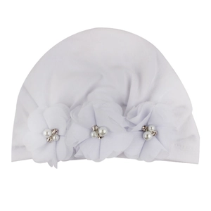 Detail of white baby beanie featuring handmade chiffon flowers with pearls and rhinestones
