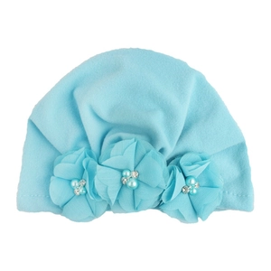 Detailed view of light blue baby turban hat with chiffon flowers, pearls and rhinestones