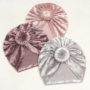 Close-up of soft velvet baby turban hats with donut knots in three pastel colors