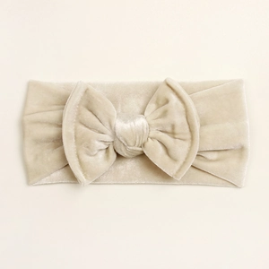 Détail du bandeau pour bébé en velours champagne doré avec un grand nœud papillon fait main