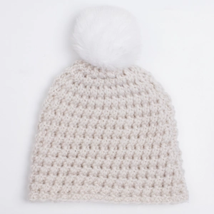 Beige chunky knit baby winter hat with a soft white faux fur pompom and ribbed texture