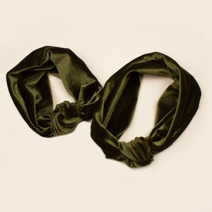 Detailed view of two-piece dark green velvet headbands with soft knotted design for family