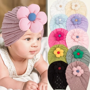 Close-up of baby hollow-out floral hats showing soft striped fabric and multi-color options