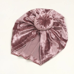 Detail of baby velvet turban hat in dusty pink with a soft knot and smooth texture
