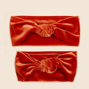 Detail of dark orange velvet knotted headbands showing soft texture and親子 size set