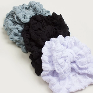Three-pack bubble texture baby turbans in grey, black and white with knot detail