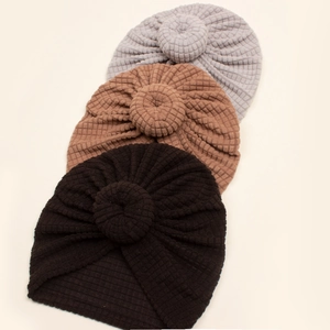Three-pack of waffle knit baby turban hats with knot detail in grey, brown, and black colors