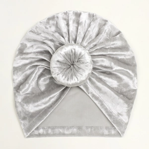 Detailed view of soft silver velvet baby turban hat with a donut knot on top
