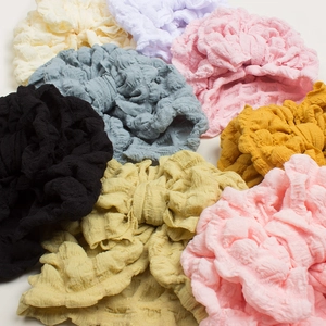 Macro shot of colorful textured bubble fabric hair scrunchies on a white background