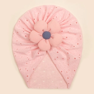 Close-up of pink baby turban hat featuring eyelet texture and a striped 3D flower detail