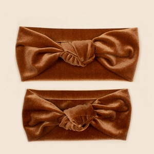 Detail of brown velvet knotted headbands showing soft texture and twisted knot design