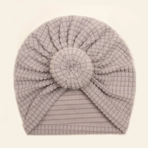 Detail of waffle texture and soft round knot on pale mauve baby turban hat