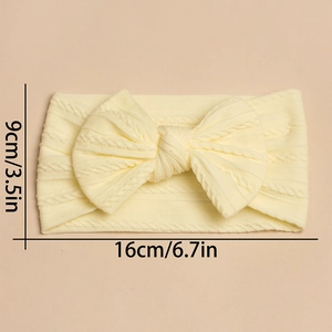 Detail of baby headband with cable knit bow texture and size markers 16cm x 9cm