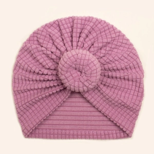 Detail of baby donut turban hat in lilac pink featuring soft waffle knit fabric texture