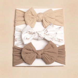 Detailed view of 3pcs baby headbands with knit textures and floral bow patterns