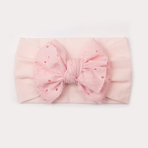 Fascia per neonati rosa elastica in nylon con un grande fiocco ricamato a traforo