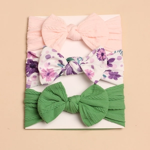 Detailed set of 3 soft knit baby headbands with large bows in pink, floral and green