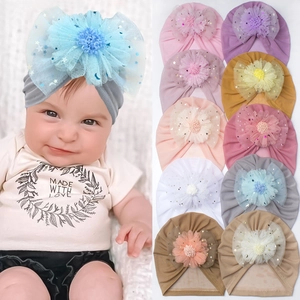 Detailed grid of baby turbans in multiple colors with sheer organza bow accents