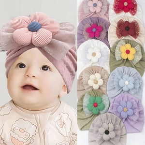 Detail of baby turban hat with large 3D corduroy flower and mesh bow in multiple colors