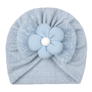 Detail of light blue baby turban hat with large decorative flower and silver glitter bow