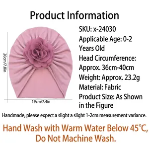 Pink infant turban hat with decorative flower and elastic fit for babies 0-2 years