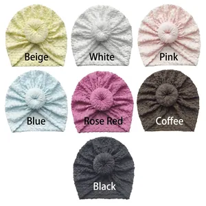 Newborn donut turban hats in multiple solid colors featuring soft textured bubble fabric