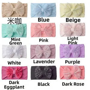Grid view showing twelve assorted colors of elastic nylon baby headbands with glitter tulle bows