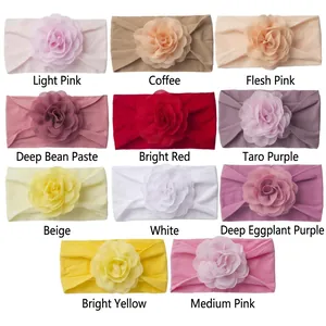 Flat lay of soft elastic baby headbands with large chiffon flowers in 11 assorted colors