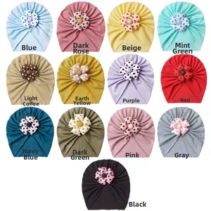 Grid view showing thirteen different colors of soft polka dot flower baby turban hats