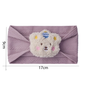 Detail view of purple knitted baby headband with a beige plush bear and size measurements