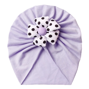 Soft purple baby beanie with polka dot flower decoration for infant head protection
