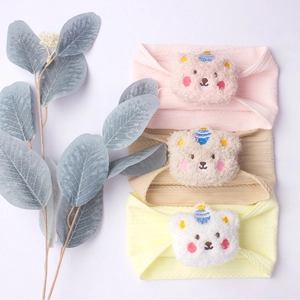3-pack of soft knitted baby headbands with cute plush bear charms in pink beige yellow