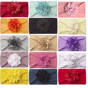 Detail view showing fifteen colors of soft cotton floral headbands for baby girls