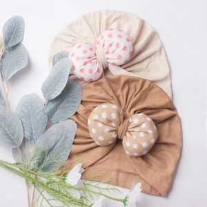 Set of 2 cute polka dot bow baby beanies in cream and light brown soft knit fabric